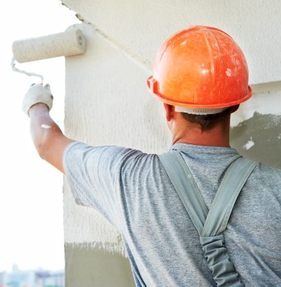 Young,Painting,Facade,Builder,Worker,With,Roller,At,Thermal,Insulation Young painting facade builder worker with roller at thermal insulation works