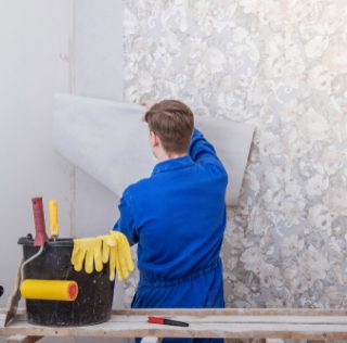 Young,Man,Doing,Repairs,In,Apartment,,Wallpapering,On,Wall Young,Man,Doing,Repairs,In,Apartment,,Wallpapering,On,Wall