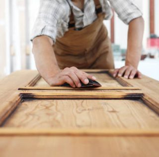 carpenter work the wood with the sandpaper carpenter work the wood with the sandpaper